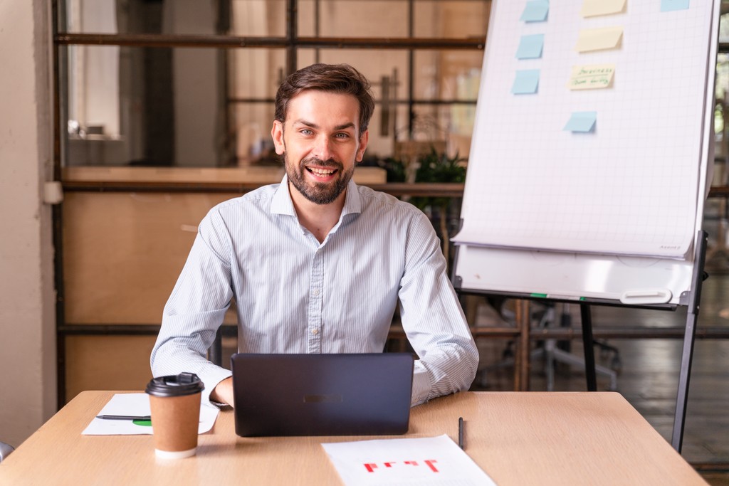 man in blue white and red plaid button up shirt wearing yellow hard hat holding black
